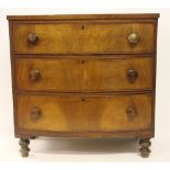 A George III mahogany bow front chest, of three long drawers, on turned legs,