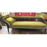 A late Victorian carved and stained chaise long, with green upholstery, on turned legs,