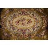 A large Chinese carpet, worked with a floral medallion against a mustard ground,