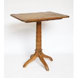 A pine tilt top occasional table, with rectangular top on a turned column and out-swept legs,