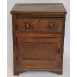 A George III oak and mahogany crossbanded cupboard, with drawer above a cupboard door,