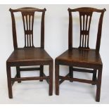 A set of four George III provincial oak dining chairs, with pierced splats and solid seats,