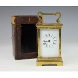 A late 19th century French gilt brass carriage time piece, with Roman numeral dial,