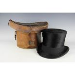 A mole skin top hat, in fitted leather case,