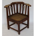 A George III oak and ash provincial corner chair,