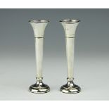 A pair of silver posy vases, Birmingham 1972, each of slender tapering form and with beaded rims,