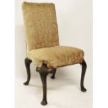 An 18th century walnut salon chair, with penwork foliate detailing,