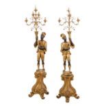 COPPIA FLAMBEAUX in ferro dorato a cinque luci sorretti da sculture in legno dorato. Firenze