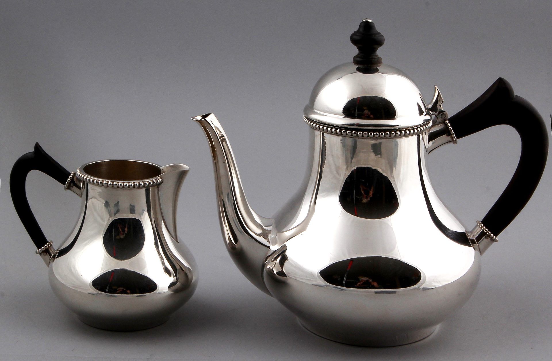 Silver tea and milk jug, 925/000, model Bonton on a roll. The jugs are equipped with wooden handle