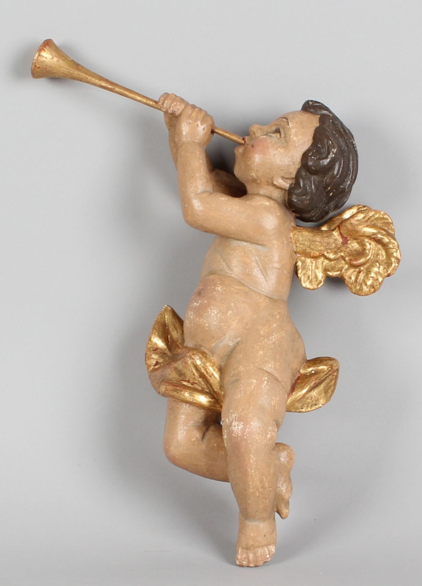 German wooden polychrome Baroque trumpet-playing angel with 20th century gilding 34cm Cond; G
