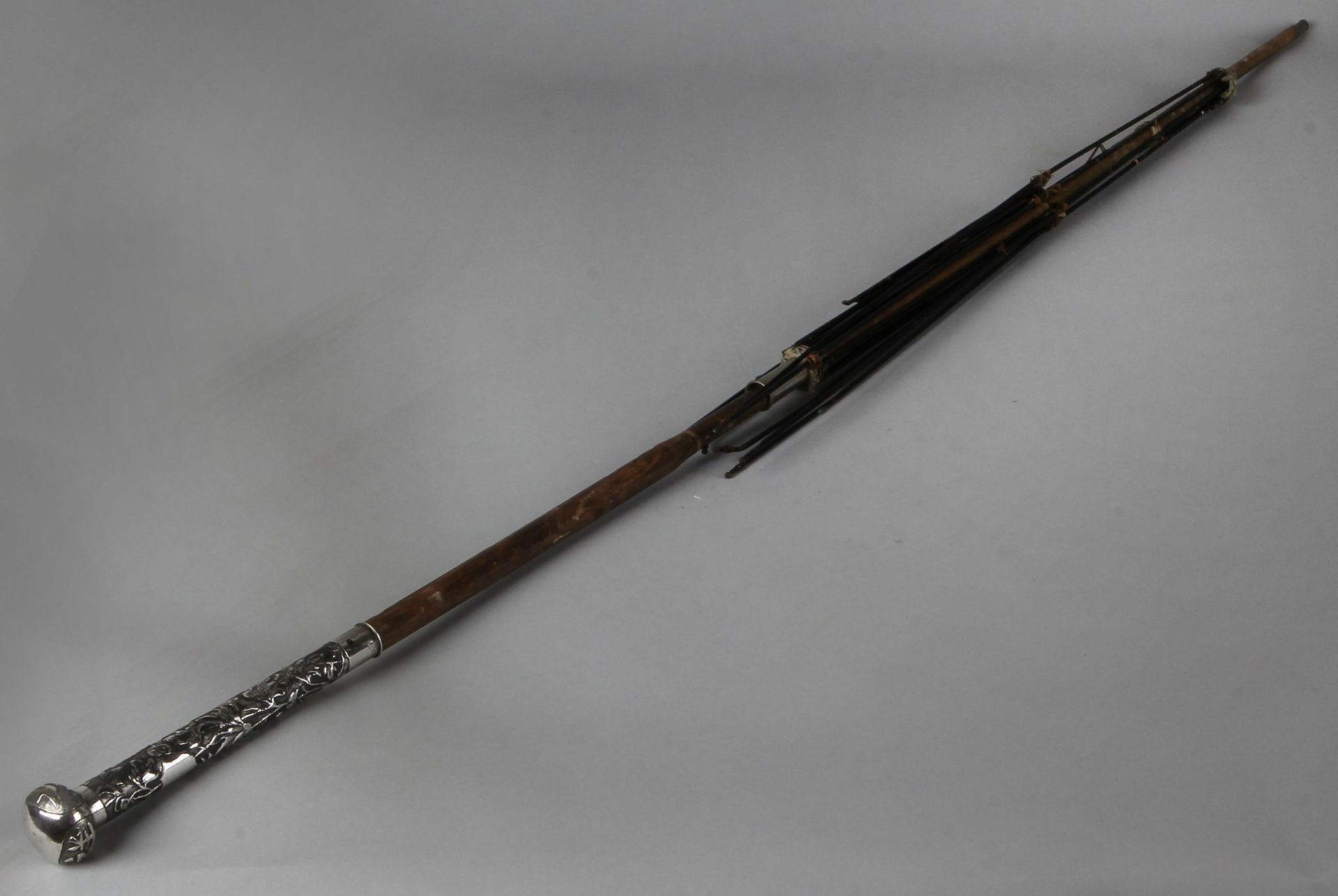 Frame of a Chinese umbrella with silver handle, provided with flower bud operation and at the tip.