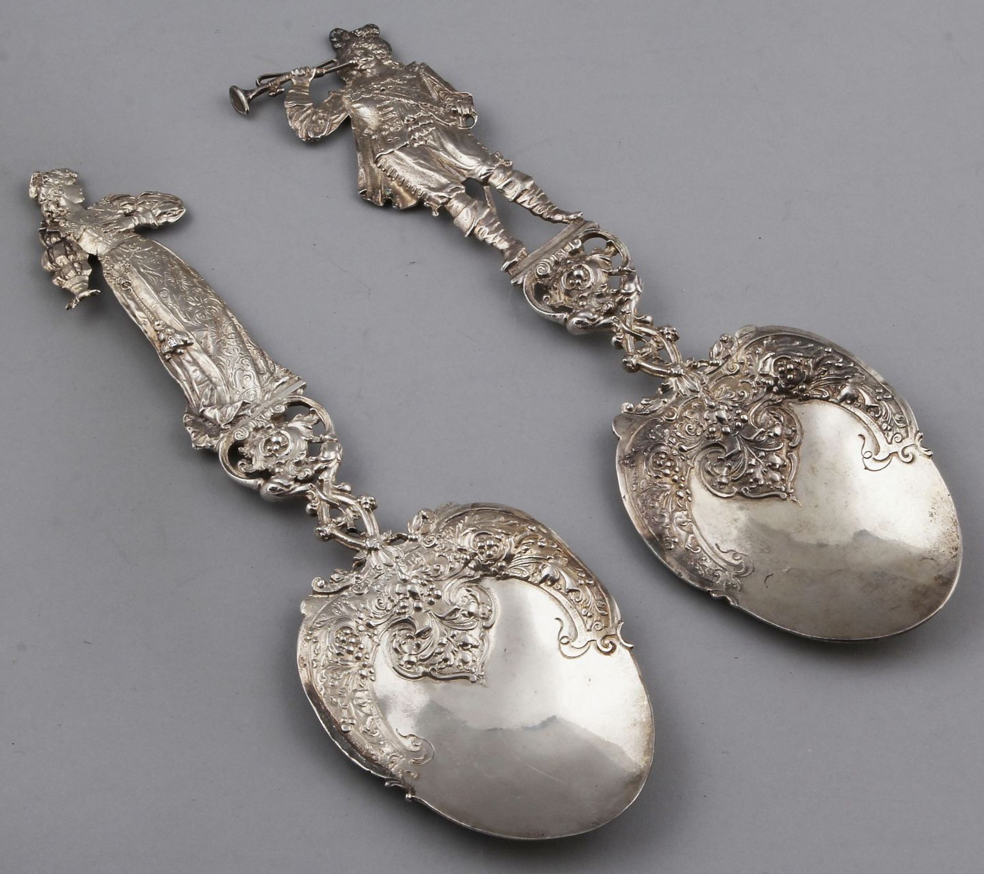 Two large silver shovels, 925/000, decorated with a man and a woman. Spoon on top of the tray