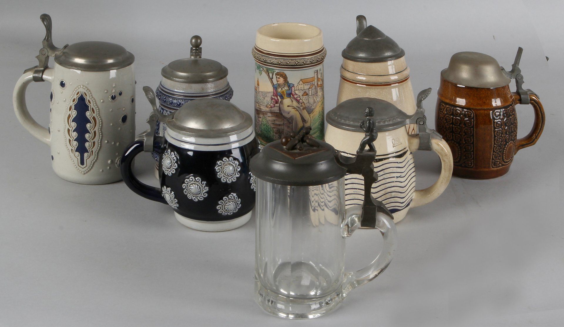 Eight different old / antique German beer steins. various types of glass with, inter alia, tin,