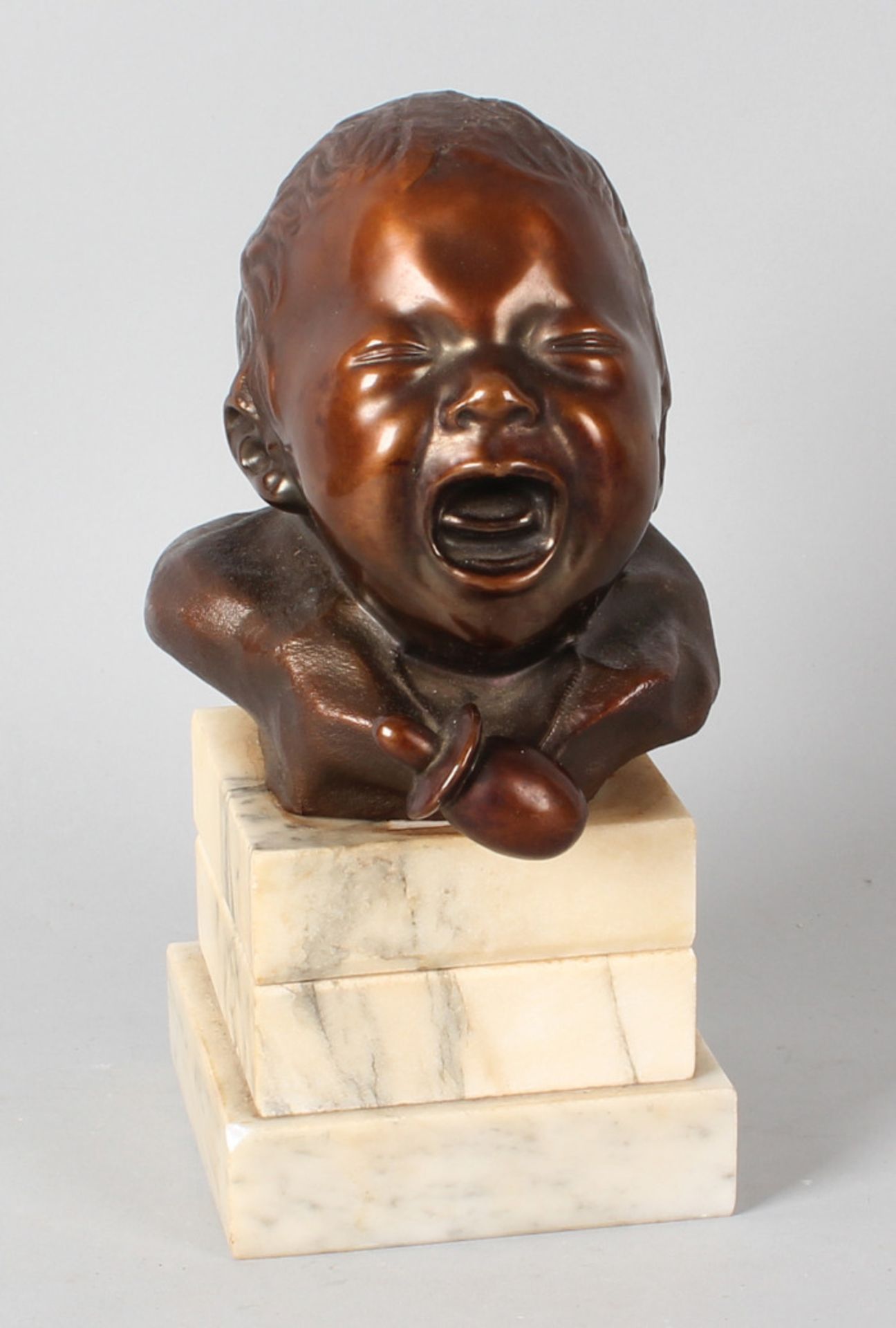 Art Deco sculpture around 1930 depicting a crying baby bust on marble base (metal composition)