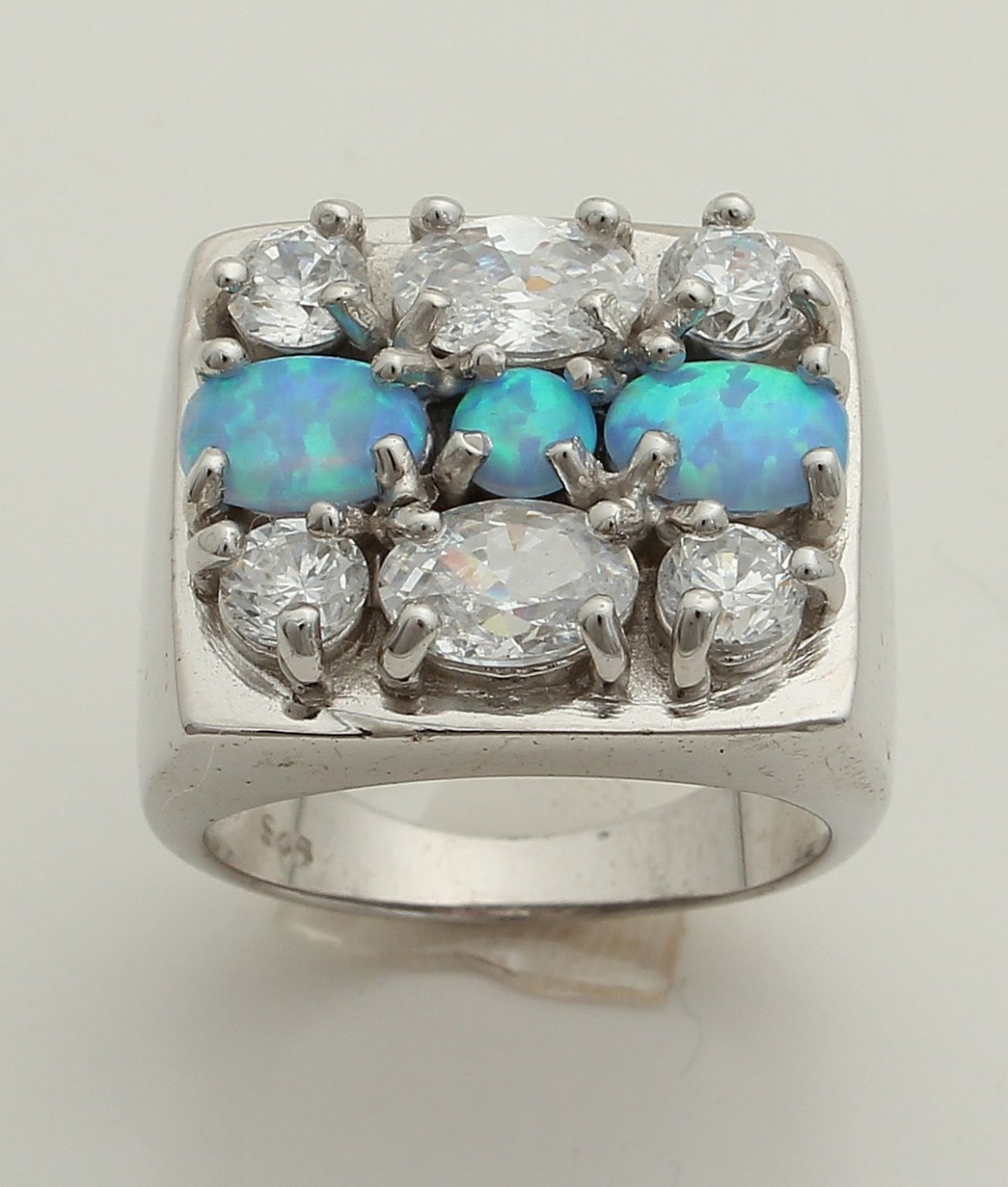 Silver ring with opal and zirconia. Wide silver ring with square head with 3 blue opals and 6
