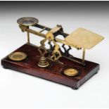 British Postal Scales British, 19th century, wood pedestal, scales and weights made of brass. Set of