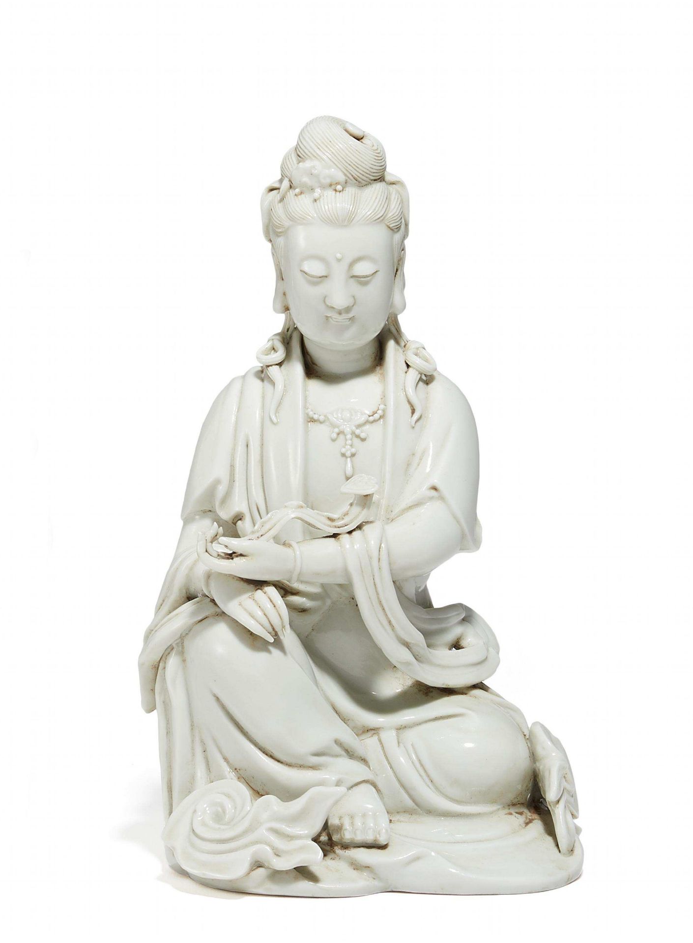 GUANYIN WITH RUYI. China. Qing dynasty. 18th c. Blanc de Chine porcelain. Sitting in lalitâsana with