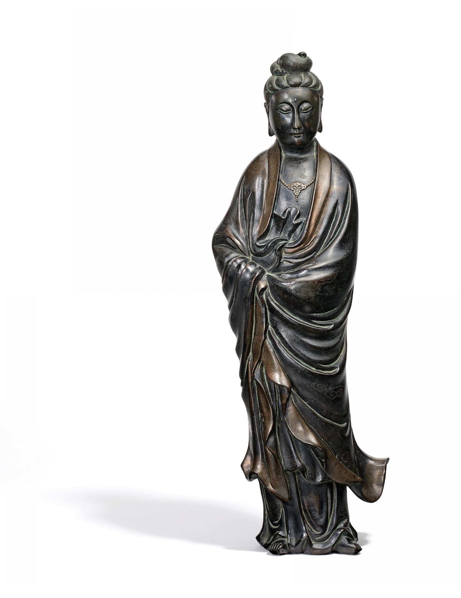 TALL GUANYIN. China. Qing dynasty or later Bronze with silver inlays and black lacquer. Guanyin as