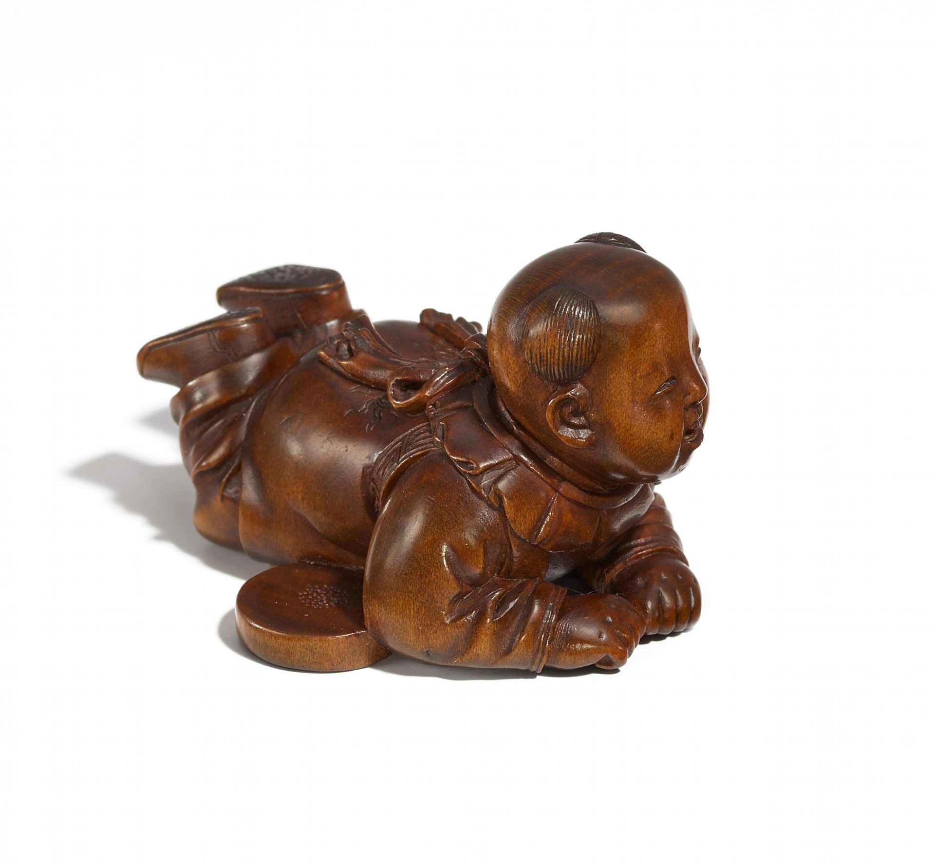 KARAKO RESTING ON HIS BELLY. Japan. Edo Period. 19th c. Boxwood, very delicately carved and