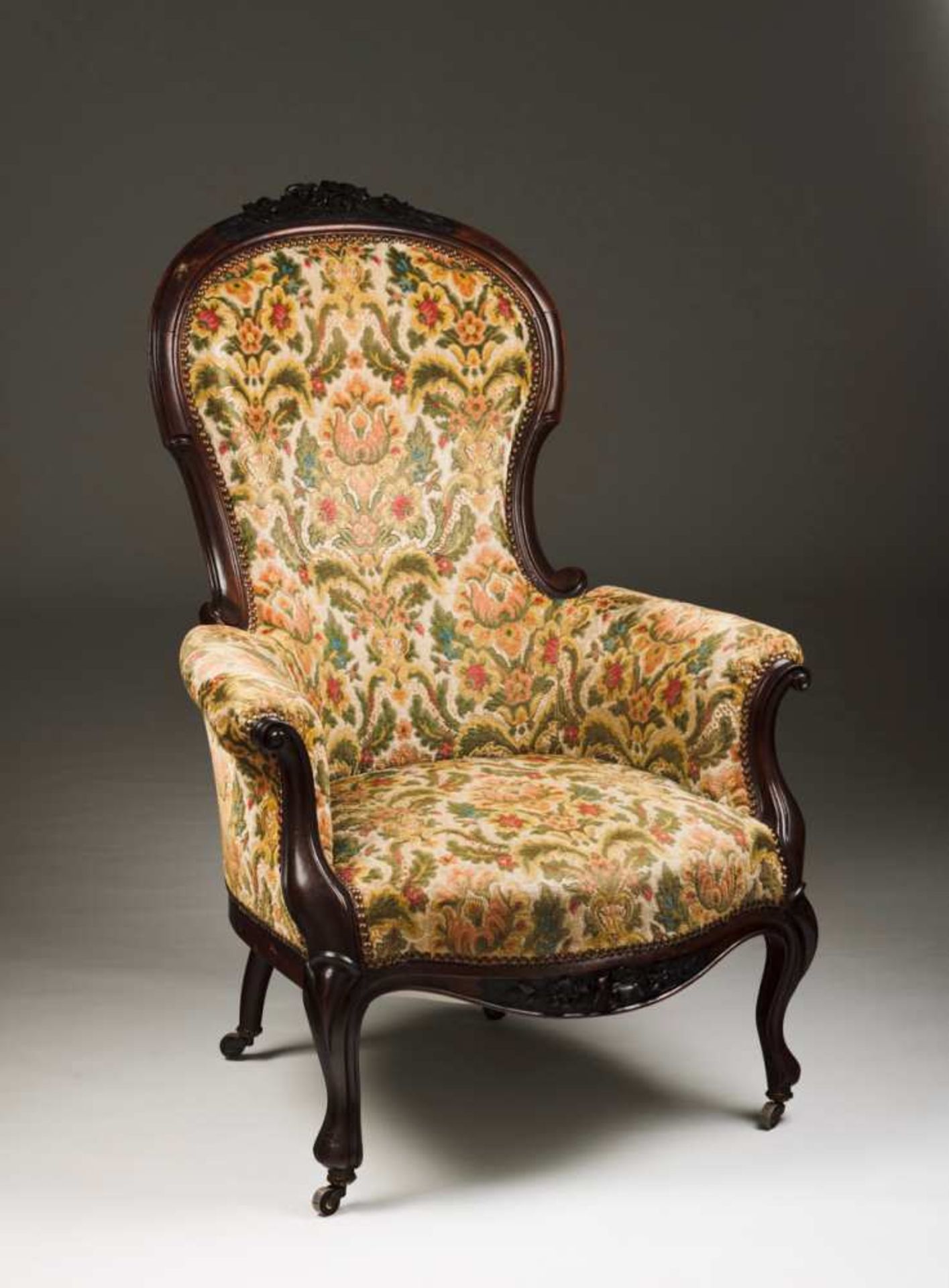 A Romantic armchair Rosewood Carved front-rail with flowers Upholstered Brass castors France, 19th