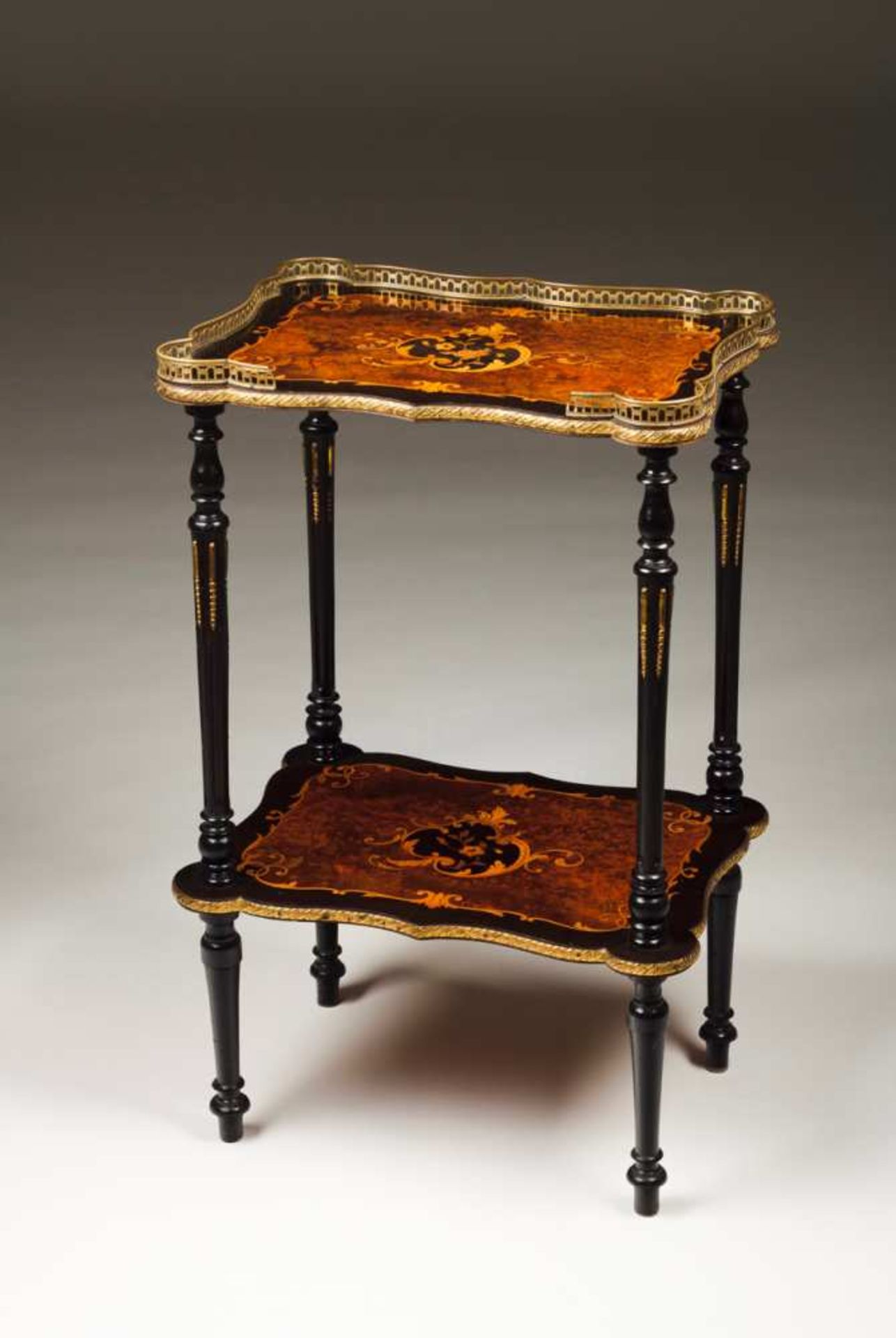 A Napoleon III Gueridon Walnut, marquetry decoration Two shelves and gallery top Brass mounts