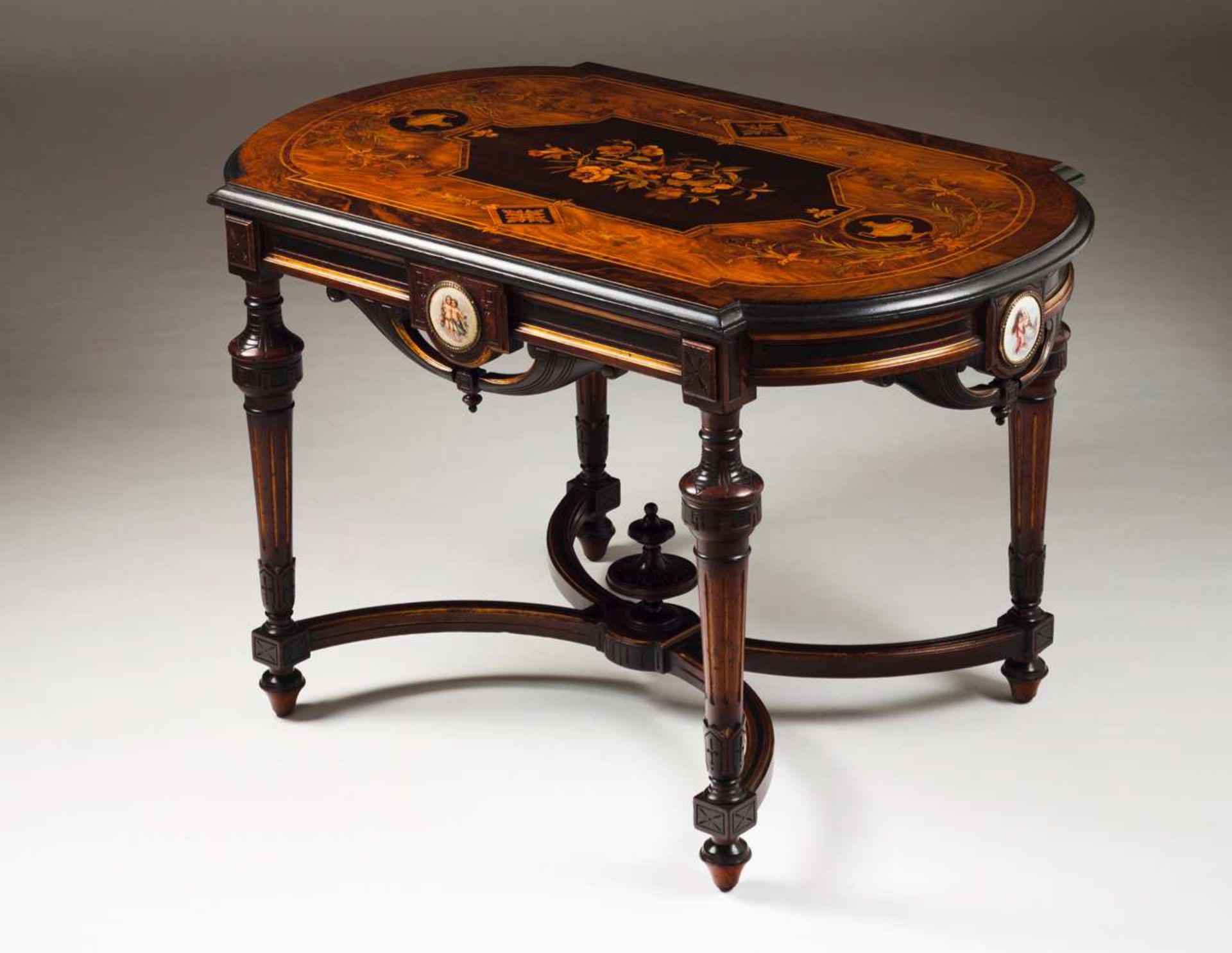 A Napoleon III centre table Marquetry decoration depicting floral motifs Enamel medallions depicting