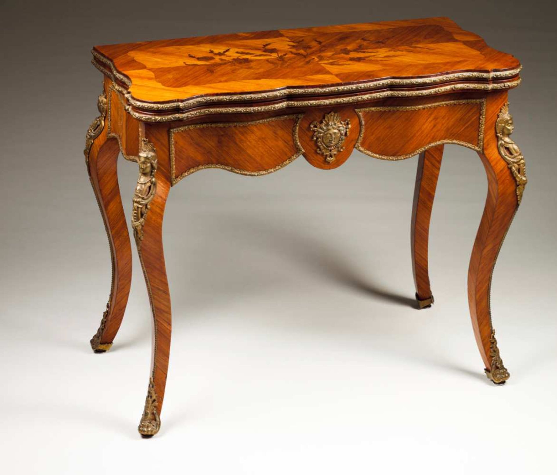 A Napoleon III style cardtable Rosewood veneered and marquetry decorated Gilt bronze mounts Tilt and