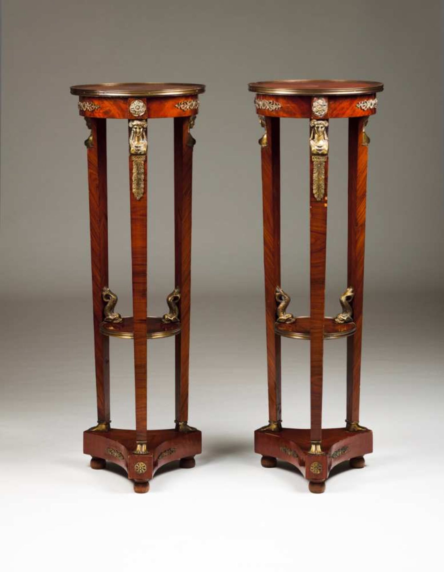 A pair of columns in the Empire style Mahogany Bronze mounts depicting dolphins, feminine figures