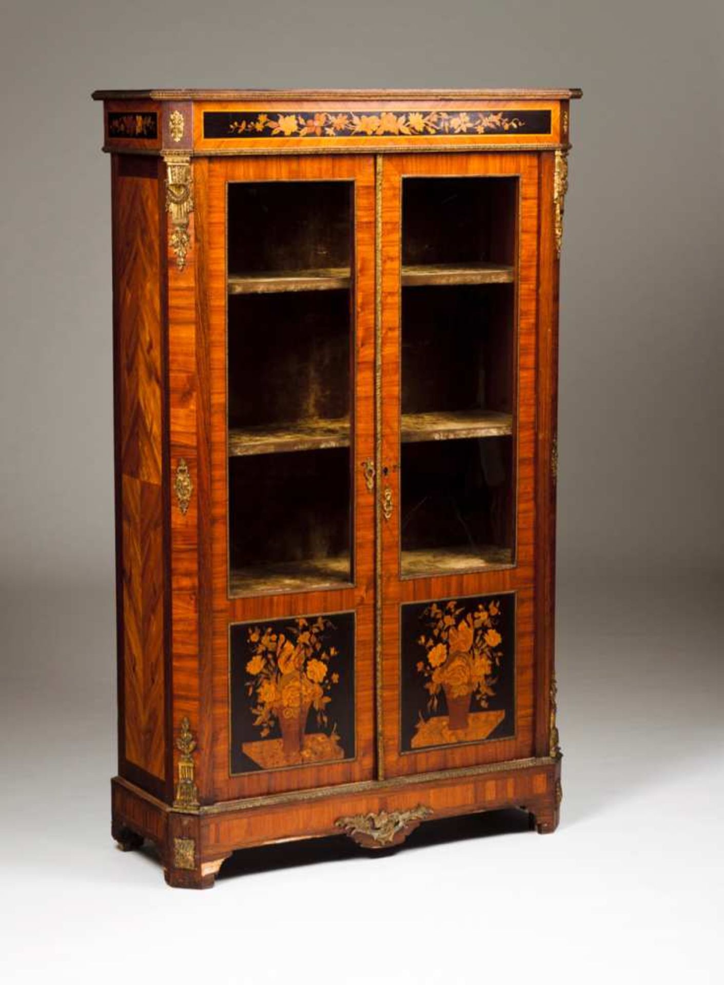 A Napoleon III showcase Mahogany with marquetry decoration depicting floral motifs, brass mounts and