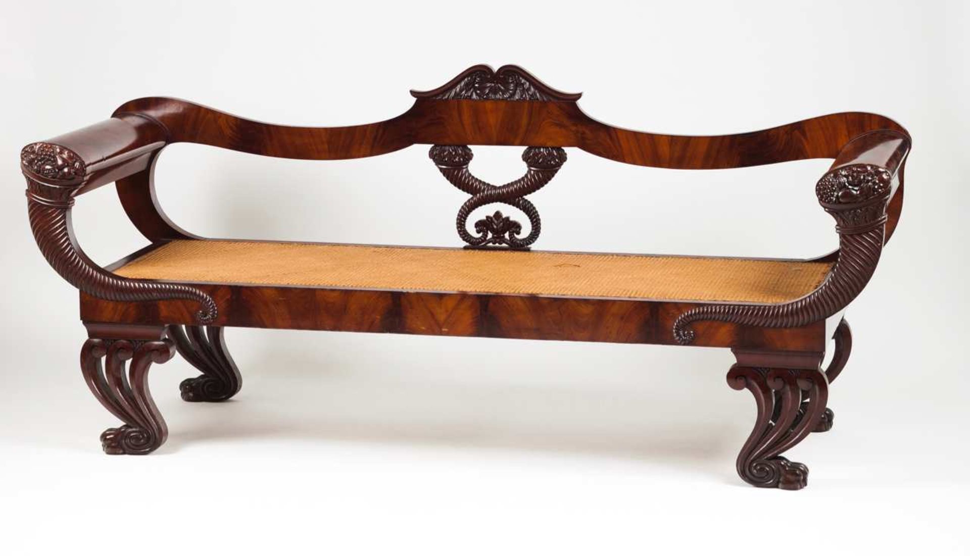 A Romantic settee Mahogany and burr-mahogany Decorated with carvings representing shell motifs and