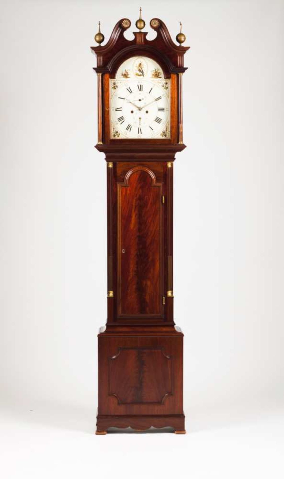 A long case clock Mahogany With brass mounts and finials Four movement mechanism signed Osborne