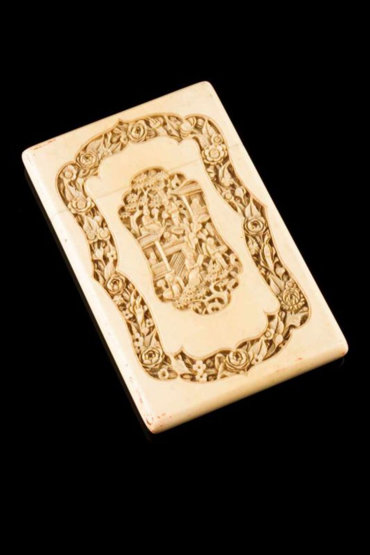 A cardbox Ivory Carved decoration depicting landscape with houses and oriental figures and floral