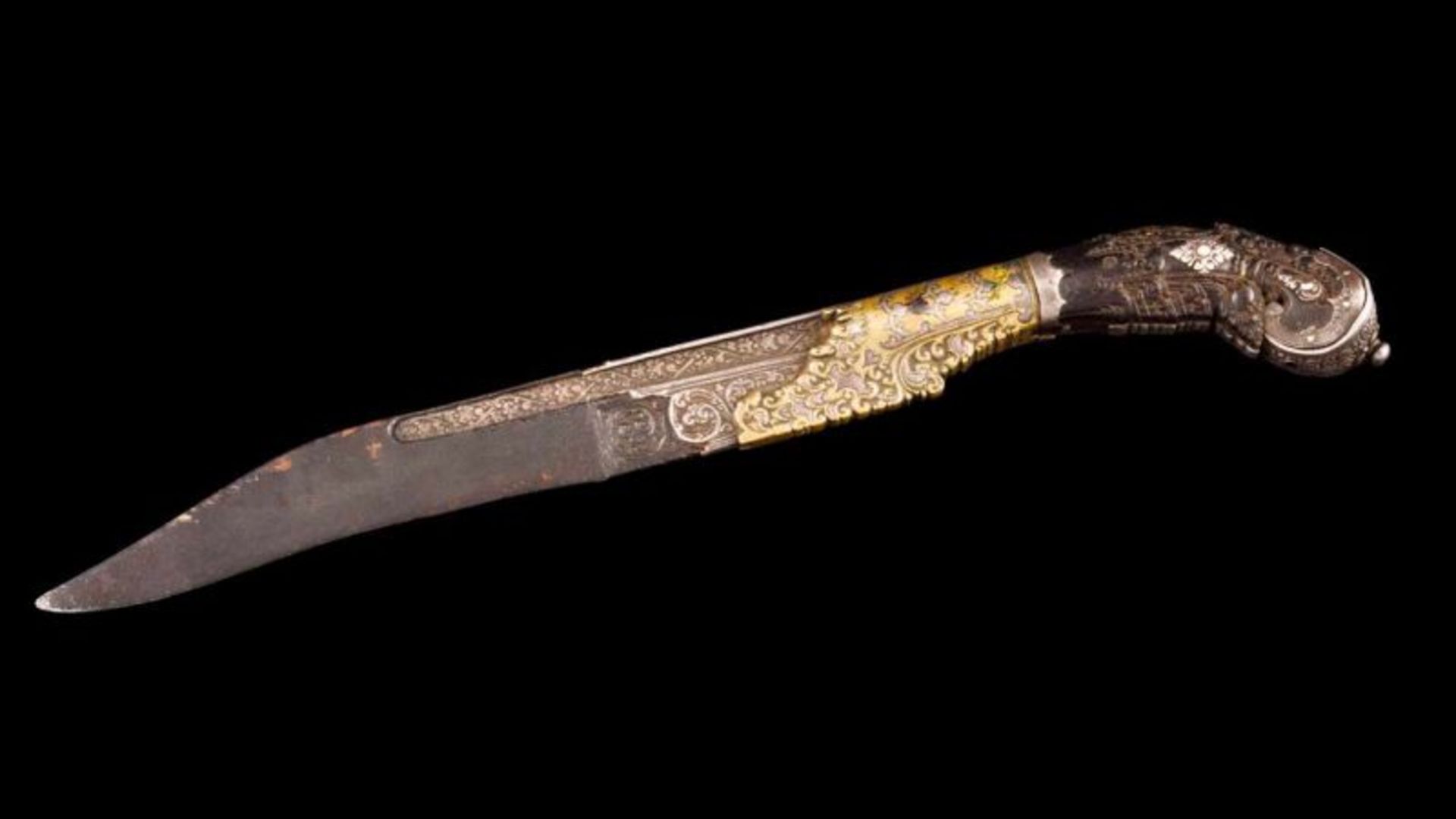 A Kaeta basin Ivory, brass and silver handle with floral motifs Iron blade Ceylon, late 17th, early