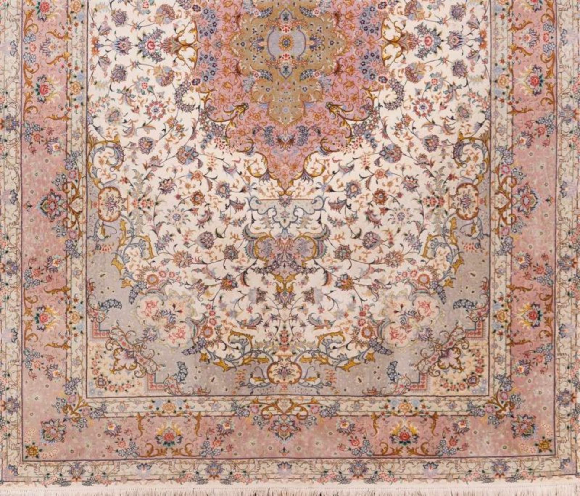 A Tabriz carpet, Iran Cotton, wool and silk Decorated with floral pattern in pink, beige, green and