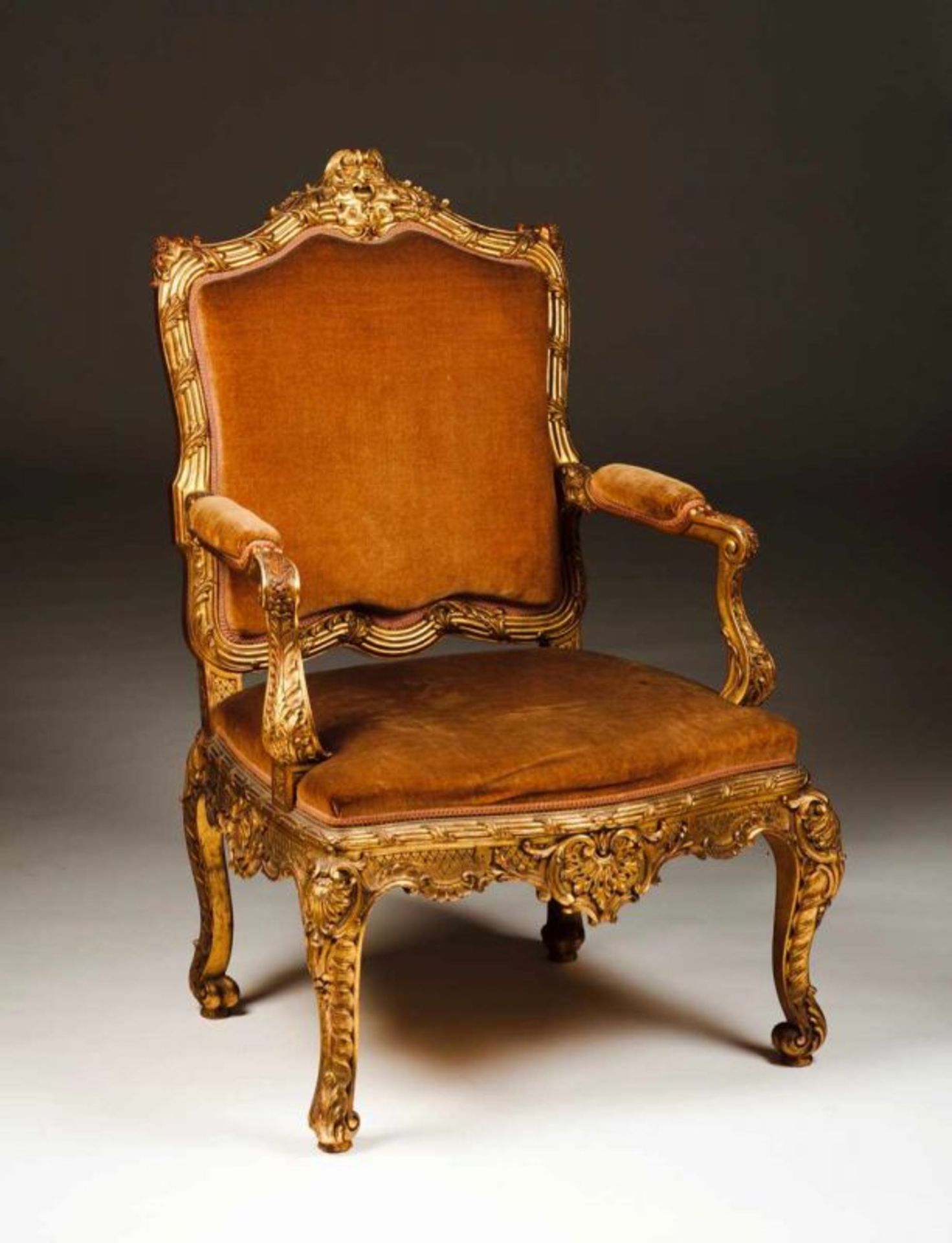 A Louis XV style fauteuil Carved and gilt wood Upholstered seat, back and arms Portugal, 20th