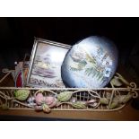 Cream coloured wire CD rack containing various items including oriental tray