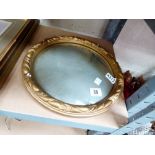 Circular mirror in brass coloured frame