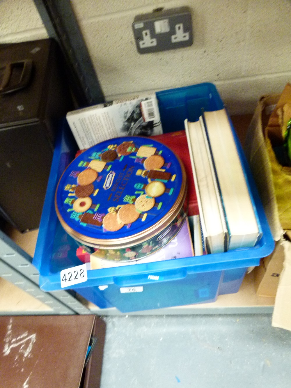 Box of mixed books and a tin of buttons