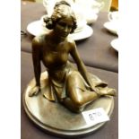 BRONZE SITTING GIRL. Bronze of a girl si