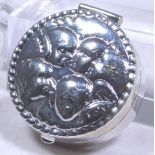 SILVER PILL BOX. Stamped silver Cherubs