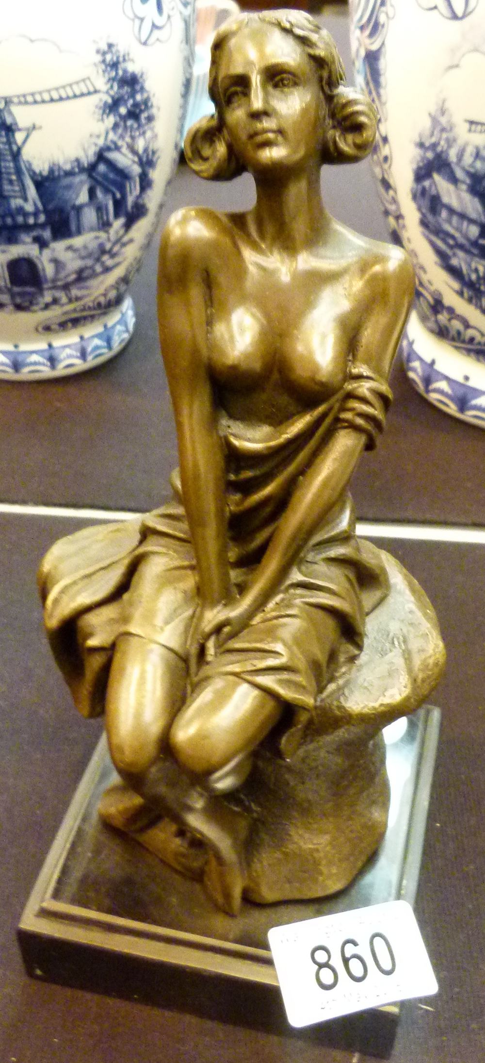 BRONZE NUDE. Bronze of nude sitting on t