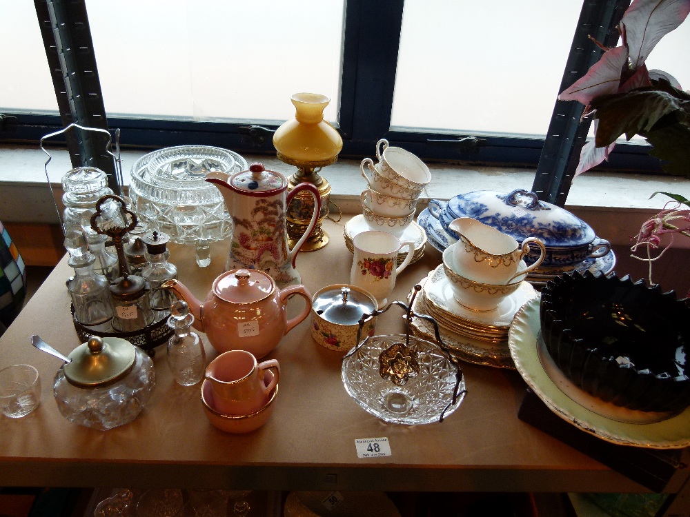 Shelf of mixed household items including ceramics and glass