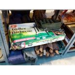 Shelf of folding garden chairs and a boxed trolley barbecue