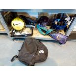 Shelf of mixed sporting items including cycle helmets, racquets,