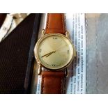 Gents gold coloured face wristwatch with brown leather strap