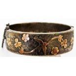 SILVER BANGLE WITH GILDED DECORATION.