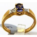 9 CT TANZANITE AND DIAMOND RING.