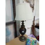 Heavy bronze table lamp with cream coloured pleated shade