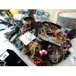 Tray of unsorted costume jewellery and watches