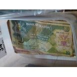 Box of Uganga banknotes and dollar coin